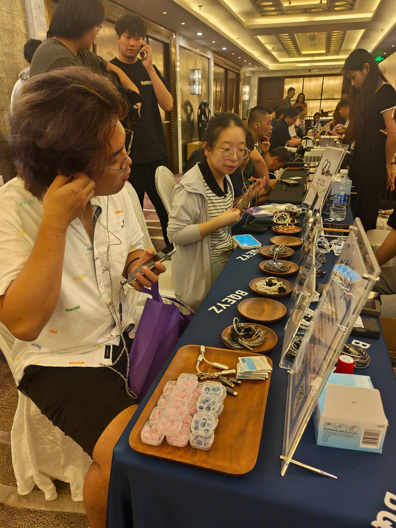 Visitors listening to BQEYZ IEMs at an audio exhibition, September 2024